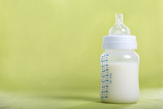 Baby milk bottle on a green sheet