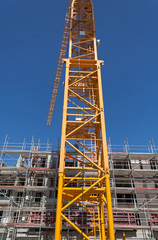 Fototapeta na wymiar Crane On The Construction Of A New Multi-storey House