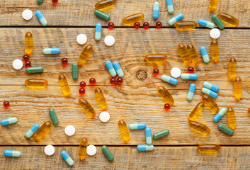 colorful medical pills isolated on wodden table