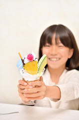 パフェを差し出す女の子（パフェにフォーカス）