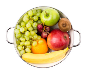 Fruit grapes, apples, bananas, berries in a bowl on a