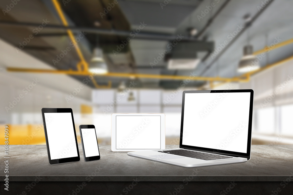 Poster Laptop, tablet and smart phone responsive display devices on table. Isolated white screen for mockup presentation. Office interior in background