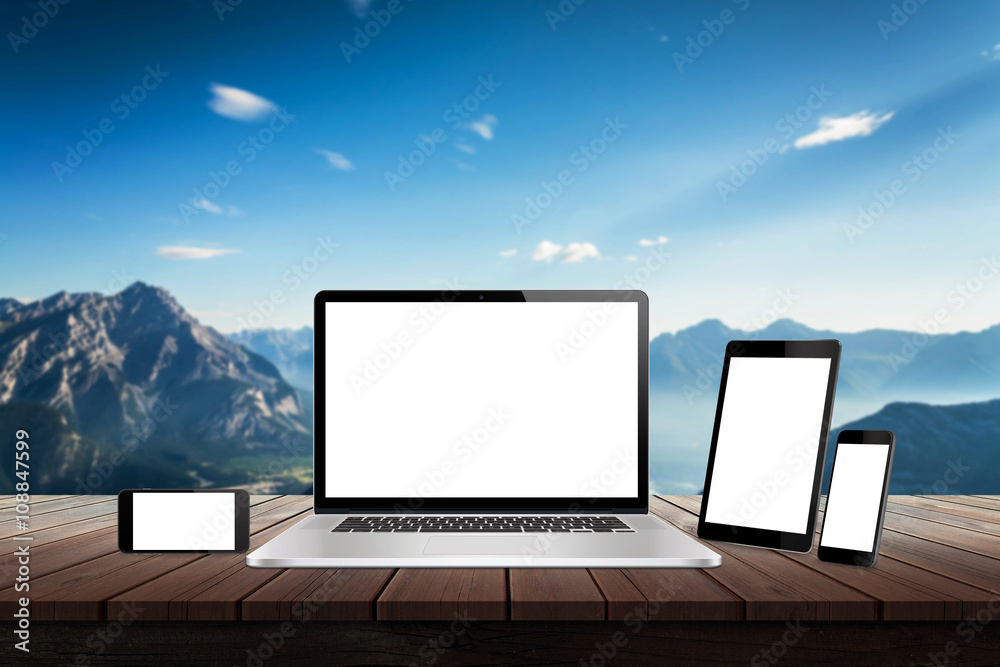 Poster Laptop, tablet and smart phone responsive display devices on table. Isolated white screen for mockup presentation. Mountain nature landscape in background