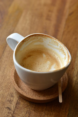 cup of espresso coffee with wooden table background