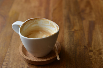 cup of espresso coffee with wooden table background