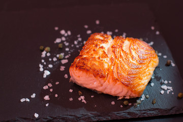 Baked salmon on a black background