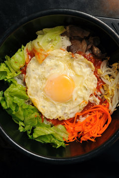 Rice with vegetable in hot bowl Korean food