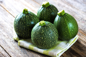 Round zucchini  on wooden background