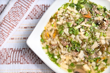 Soup with pieces of lamb, mushrooms and vegetables