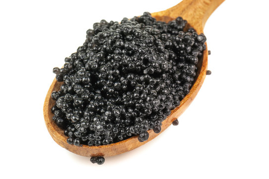 black caviar in wooden spoon