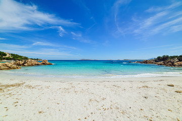Capriccioli beach under a cloudy sky
