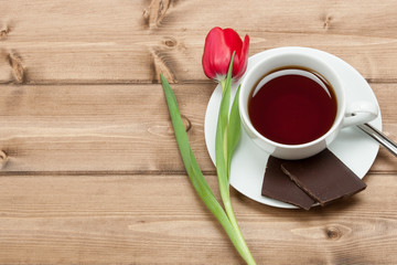 Tea Cup, Tulip Flower, Chocolate. Wooden Table. Top View. Copy S
