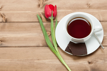 Tea Cup, Tulip Flower, Chocolate. Wooden Table. Top View. Copy S