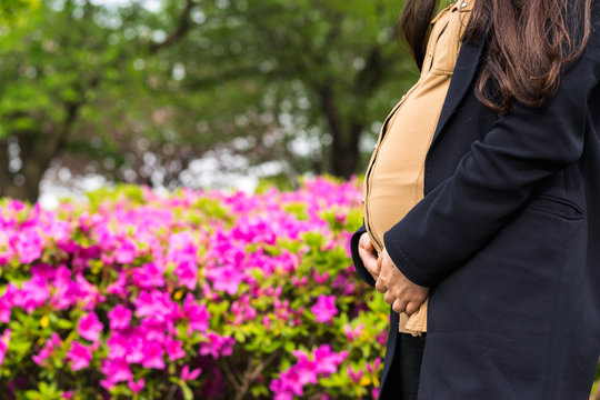Pregnant girl in front of flowers