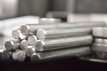 stainless steel rods on a welding table - obrazy, fototapety, plakaty
