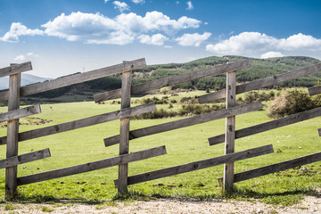 Fototapeta na wymiar Wooden fence on a mountain ranch