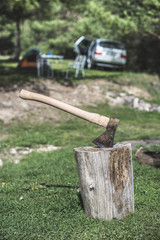 Ax stuck on a stump in the forest