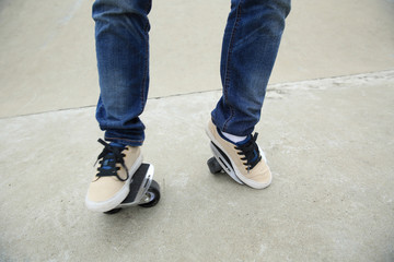 Fototapeta na wymiar skateboarding legs riding on freeline at skatepark