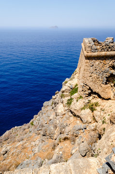 The view from the walls of the dilapidated old stone fortress of the turquoise sea and the distant horizon