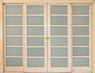wooden sliding door with glass inserts.