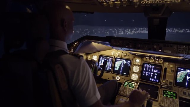 Cockpit view as pilot flies a jumbo jet over northern California, USA, at night.  Stabilized hand-held camera, originally recorded in 4K at 30ps.