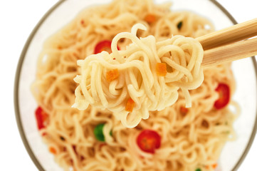 Bowl of instant noodles with peas and chili, isolated on white b