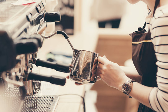 Barista preparing coffee in a cafe. Professional coffee brewing, service and catering concept