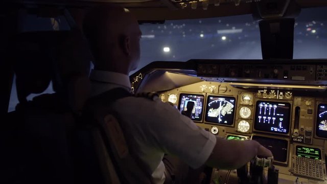 Night-time cockpit view as African American pilot taxis a Boeing 747 at San Francisco airport.  Stabilized hand-held camera, originally recorded in 4K at 30ps.