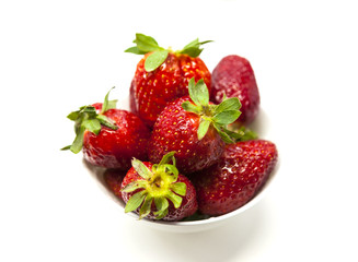 Fresh strawberries on a plate on white background