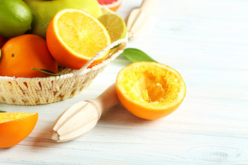 Citrus fruits with juicer on a blue wooden table