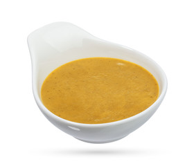 Mustard in bowl isolated on white background.