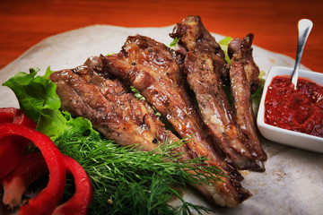 Grilled ribs on a wooden board