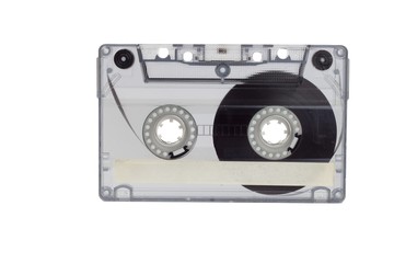 Old audio cassette isolated on white. Dusty damaged audio cassette, historical sound recording on magnetic tape. Place for your text.
