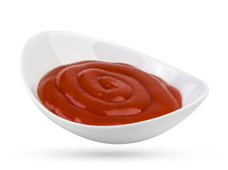 Tomato ketchup in bowl isolated on white background. Portion of tomato sauce with clipping path.