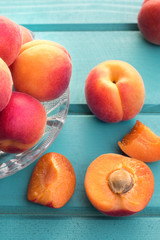 Fresh homegrown apricots on pastel blue wooden table