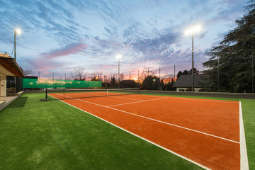 Tennis court at private estate in twilight and magic sky - obrazy, fototapety, plakaty