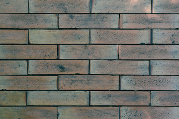 Weathered stained old brick wall background.