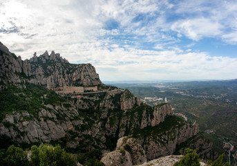 Fototapeta na wymiar Aerial view of the Montserrat monastery. Santa Maria de Montserrat is a Benedictine abbey located on the mountain of Montserrat, in Monistrol de Montserrat, in Catalonia, Spain