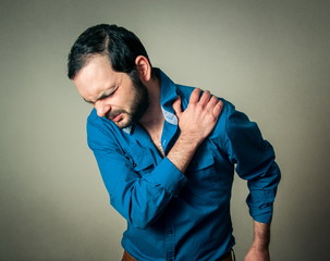 bearded man has a shoulder pain