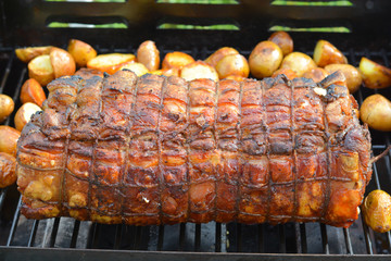 Cooked roast of pork or italian porchetta recipe on a grill