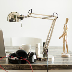 Artistic working desk, lamp,laptop,mobile phone,headphones, coff