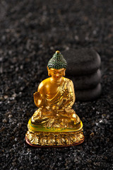 Massage spa stones and statue Buddha on black background