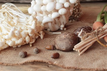 Mushrooms and vegetables on wood background.
