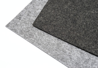 Fototapeta premium gray felt pieces on a white background.