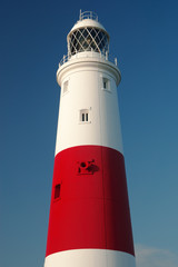 Portland Bill Lighthouse in dorset against a dark blue sky