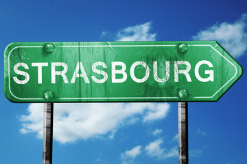 strasbourg road sign, vintage green with clouds background