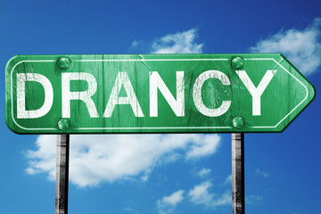 drancy road sign, vintage green with clouds background