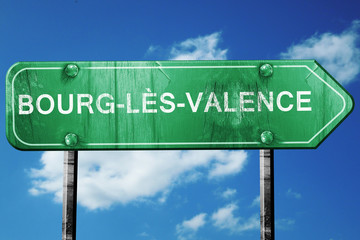 bourg-les-valence road sign, vintage green with clouds backgroun