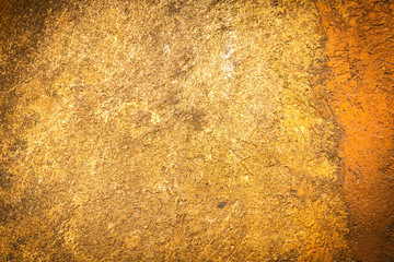 Abstract background texture cement wall in  orange yellow tone.