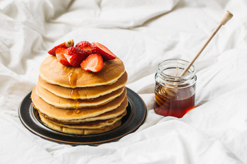breakfast in the bad with pancakes and strawberry